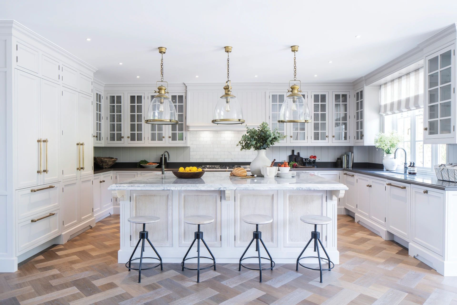 Classic Edwardian kitchen with marble topped island and brass handles and knobs.