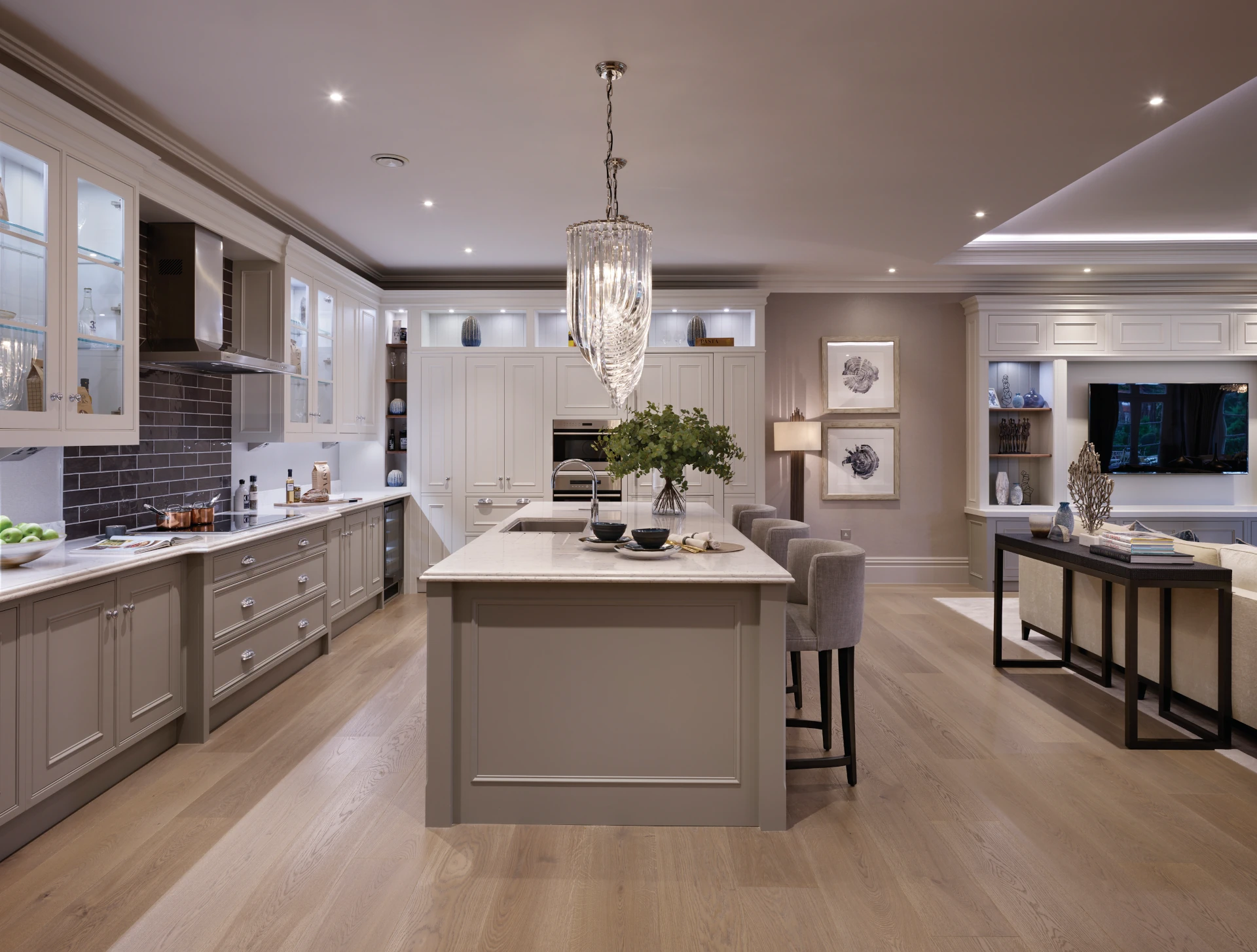 Classic neutral kitchen with island and hanging lighting above.