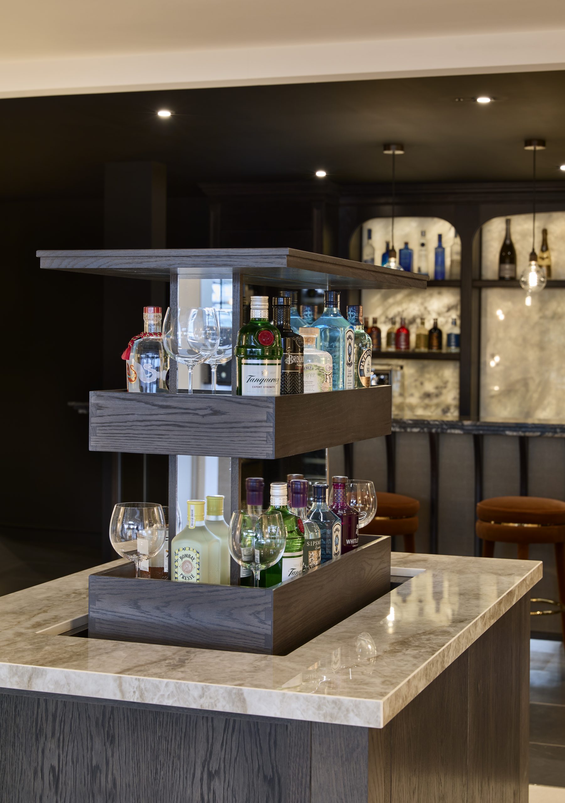 Pop up gin bar finished in a dark stained slab wood door and stunning neutral worktop. 