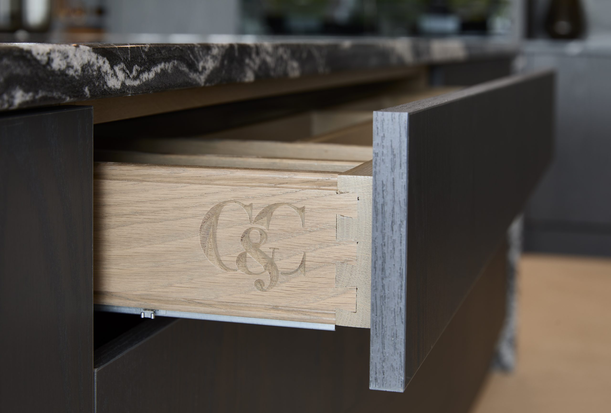 Cooks & Company’s attention to detail featuring engraved logo into hardwood drawer.